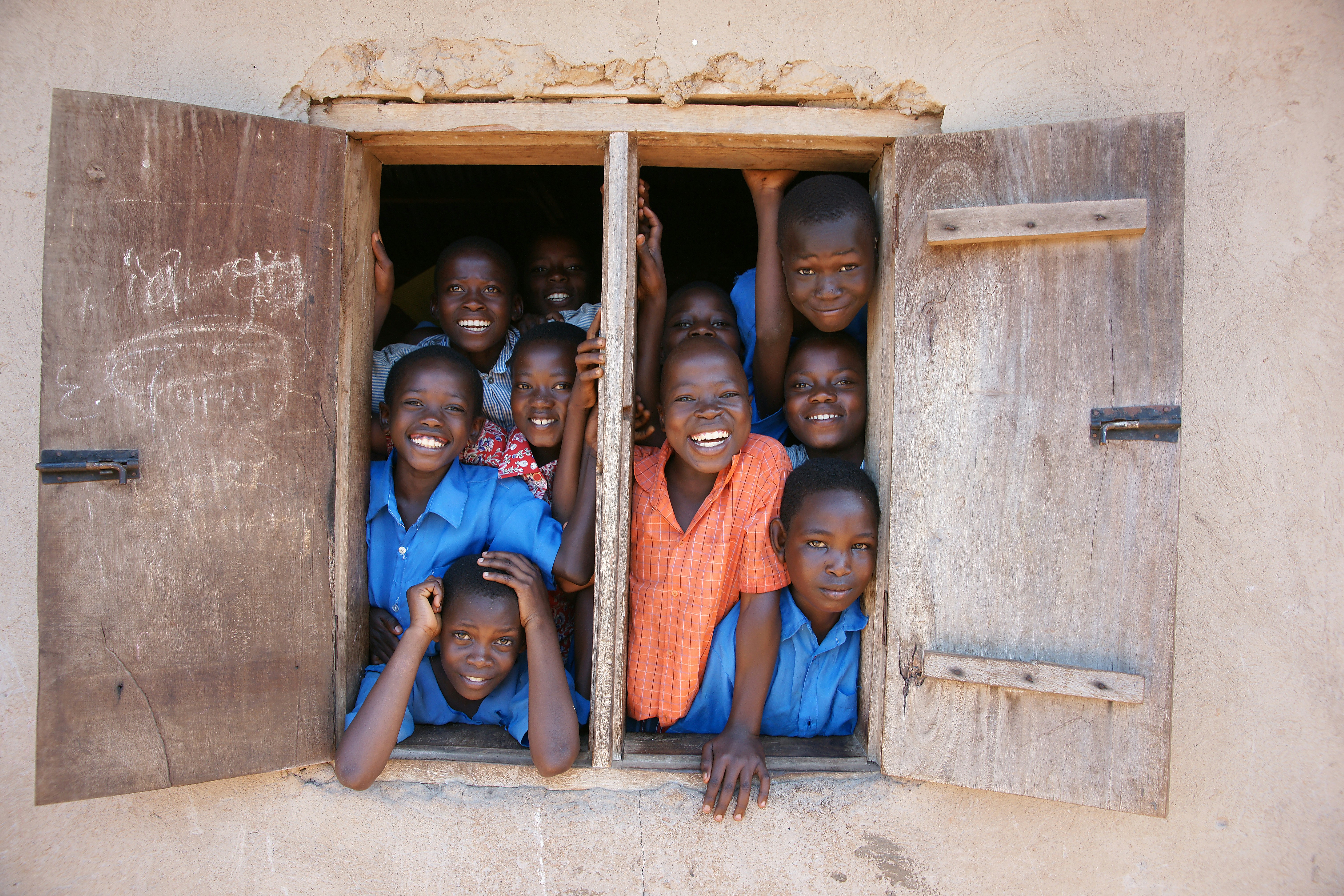 Children smiling through a window
